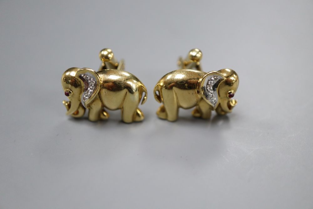 A pair of modern yellow metal (stamped 750), diamond and cabochon ruby set elephant cufflinks, 20mm, gross 14 grams.